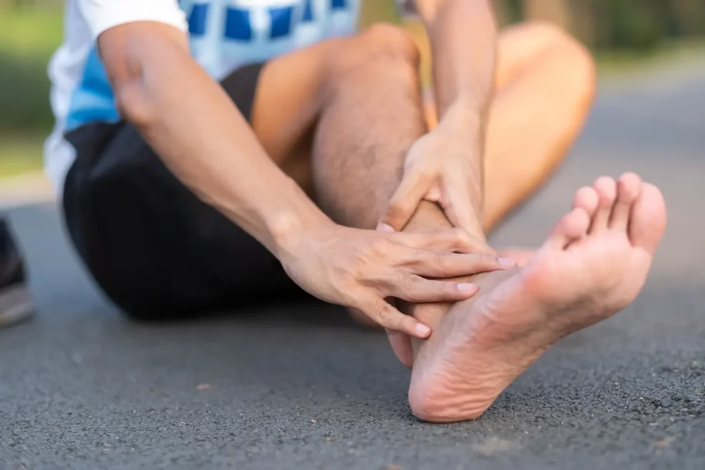 Man rubbing hurt foot